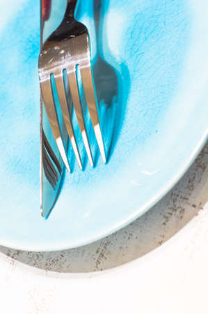 Table setting with modern style plate and silverware on white wooden table with copyspaceの写真素材