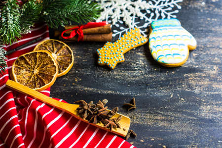 Christmas table setting with bright napkin, spices, decorations and vintage silverware on rustic wooden tableの写真素材