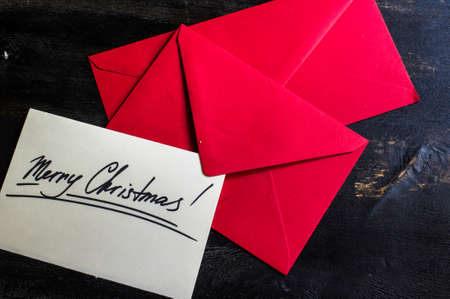 Red envelops with festive note on white card