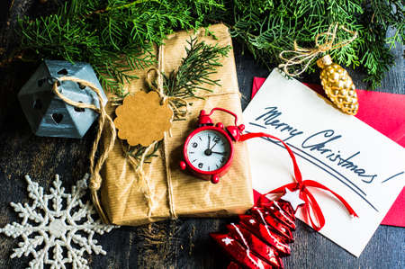 Gift boxes and cards for Christmas celebration with festive decorations on rustic wooden backgroubd with copyspaceの写真素材