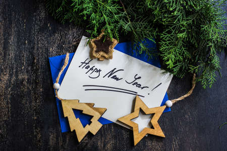 Gift boxes and cards for Christmas celebration with festive decorations on rustic wooden backgroubd with copyspaceの写真素材