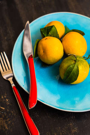 Fresh organic tangerine fruits on rustic wooden table and copyspaceの写真素材