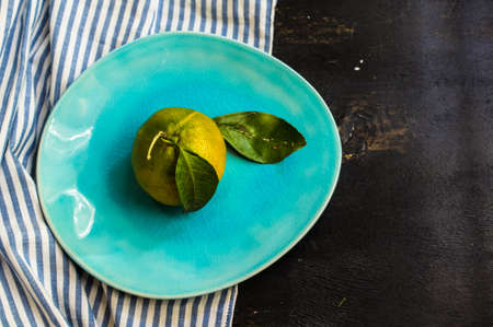 Fresh organic tangerine fruits on rustic wooden table and copyspaceの写真素材