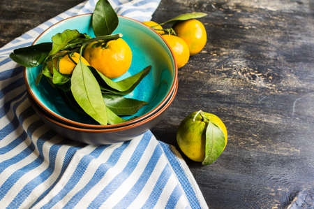 Fresh organic tangerine fruits on rustic wooden table and copyspaceの写真素材