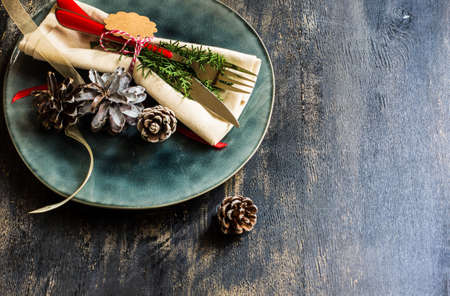 Festive table setting for Christmas eve in rustic style on dark wooden backgroundの写真素材