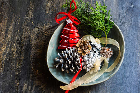 Festive table setting for Christmas eve in rustic style on dark wooden backgroundの写真素材