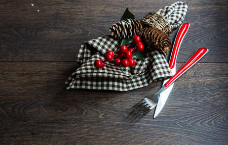 Rustic table setting for Christmas eve on rustic dark table