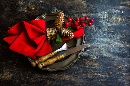 Rustic table setting for Christmas eve on rustic dark tableの写真素材