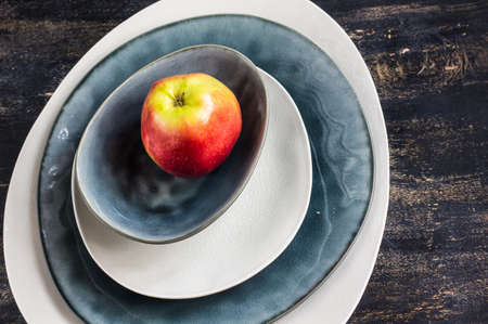 Fresh organic apple on dark wooden table with copyspace