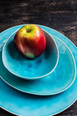 Fresh organic apple on dark wooden table with copyspaceの写真素材
