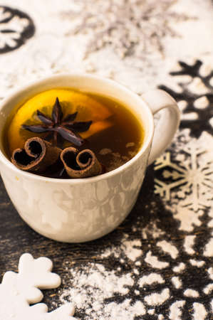 Cup of Tea with a Lemon and Cinnamon on Christmas background with snow in rustic style with copyspaceの写真素材