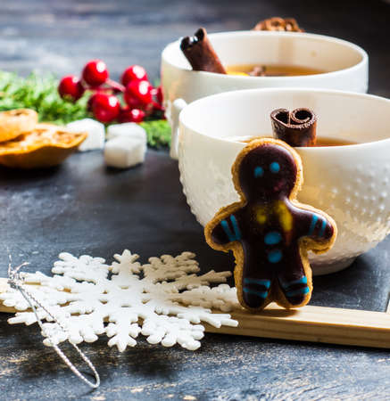 Cup of Tea with a Lemon and Cinnamon on Christmas Background. Rustic style