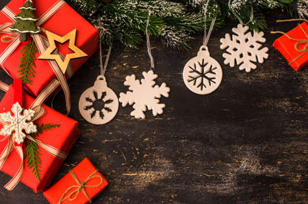 Red Christmas gift boxes in rustic style with holiday decorations, selective focusの写真素材