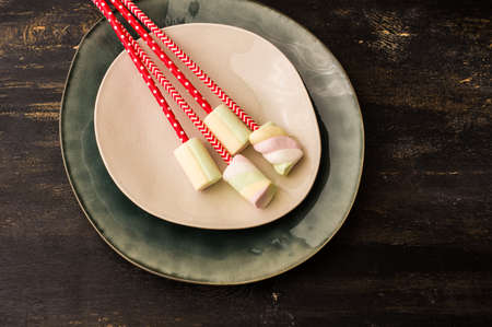 Christmas or New Year composition with hot chocolate and marshmallows, decorated with fir cones and holiday balls and jingle bells on  dark vintage wooden background,の写真素材