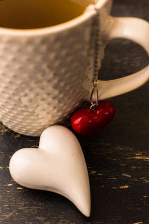 Cupof tea for St. Valentines Day celebration on dark wooden backgroundの写真素材