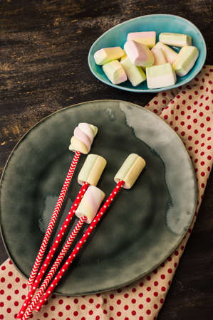 Christmas or New Year composition with hot chocolate and marshmallows, decorated with fir cones and holiday balls and jingle bells on  dark vintage wooden background,の写真素材