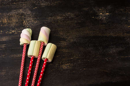 Christmas or New Year composition with hot chocolate and marshmallows, decorated with fir cones and holiday balls and jingle bells on  dark vintage wooden background,の写真素材