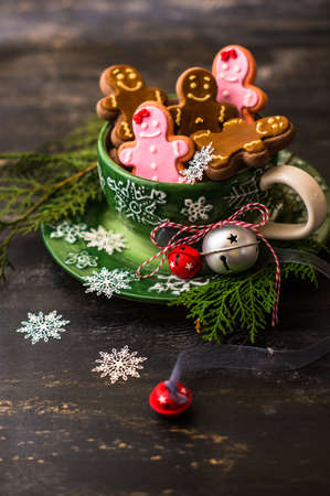 Christmas concept with gingerbread man cookie on dark wooden backgroundの写真素材