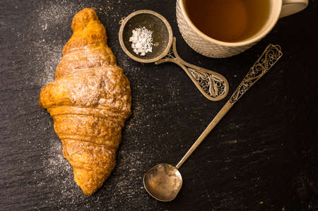 French croissant on black stone background with copyspaceの写真素材