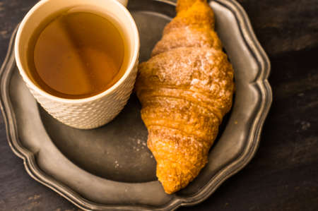 French croissant on black stone background with copyspaceの写真素材