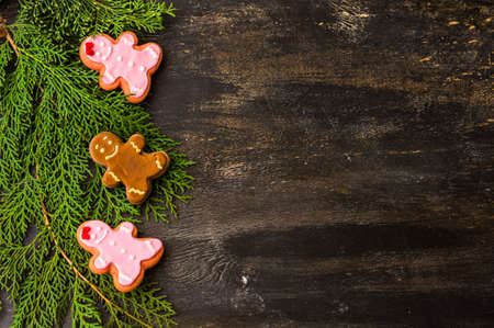 Christmas concept with gingerbread man cookie on dark wooden backgroundの写真素材