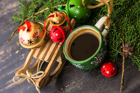 Cup of coffee with christmas decorations on dark wooden table with copyspaceの写真素材