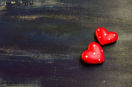 Present for St. Valentines Day  with red ribbon on rustic wooden background with copyspace