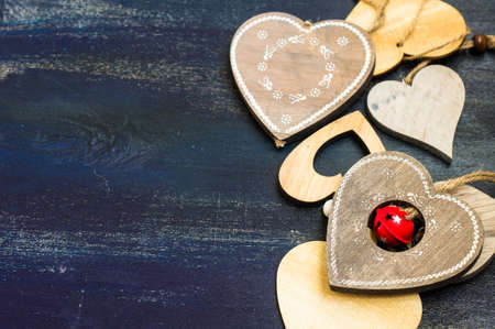 Present for St. Valentines Day  with red ribbon on rustic wooden background with copyspace