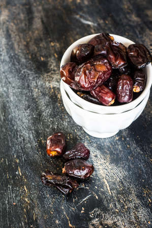 Raw Organic Medjool Dates Ready to Eat on dar wooden tableの写真素材