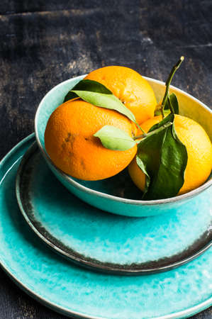 Ripe organic oranges on dark rustic wooden tableの写真素材
