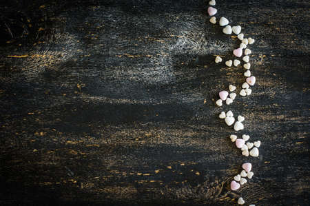 Festive frame with hearts on dark background with copyspaceの写真素材