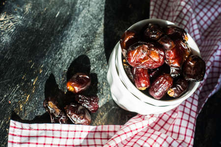 Raw Organic Medjool Dates Ready to Eat on dar wooden table