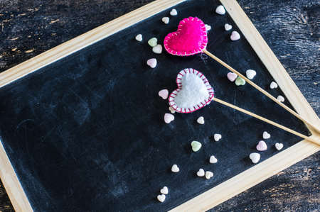 Festive frame with hearts on dark background with copyspaceの写真素材