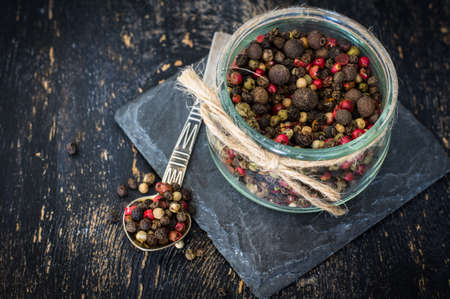 Mixed red, white and black peppercorns closeup. May used as backgroundの写真素材