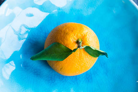 Ripe organic oranges on dark rustic wooden tableの写真素材