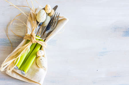 Table setting for Easter dinner with eggs on white wooden tableの写真素材