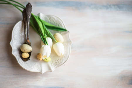Table setting for Easter dinner with eggs on rustic wooden tableの写真素材