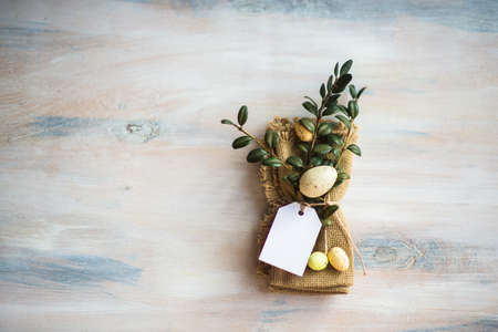Table setting for Easter dinner with eggs on rustic wooden table