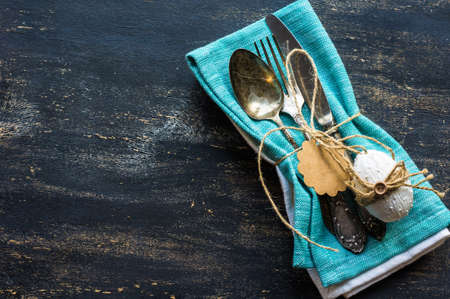 Table setting for Easter dinner with tulips and eggs on rustic wooden tableの写真素材
