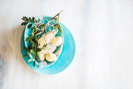 Table setting for Easter dinner with eggs on rustic wooden tableの写真素材