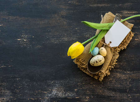 Table setting for Easter dinner with eggs on rustic wooden table