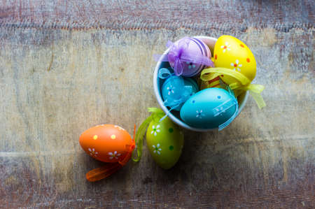 Table setting for Easter dinner with tulips and eggs on rustic wooden tableの写真素材