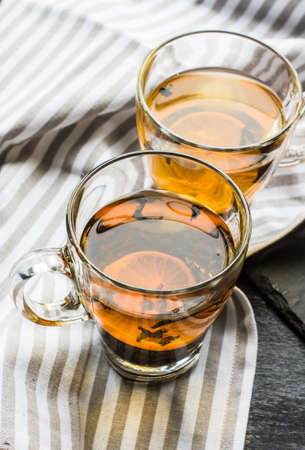 Cup of tea with lemon on dark rustic wooden table with copyspaceの写真素材