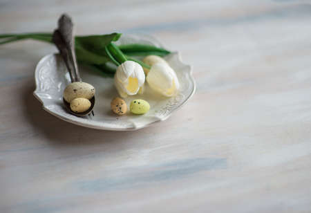 Table setting for Easter dinner with eggs on rustic wooden table