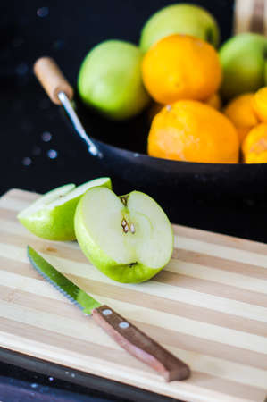 Seasonal fruits like a orange and apples in a kitchenの写真素材