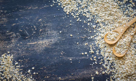 Healthy food concept with oats meal on dark rustic background with copyspaceの写真素材