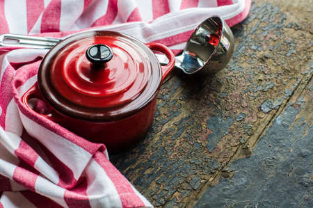 Cooking pot and napkin on rustic wooden backgroundの写真素材