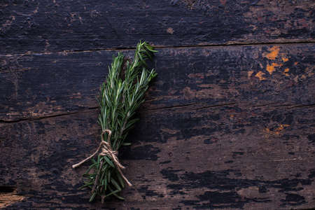 Fresh rosemary spice on rustic wooden background with copyspaceの写真素材