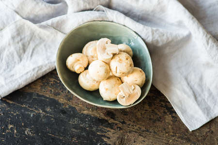 Organic food concept with fresh mushrooms on dark wooden tableの写真素材
