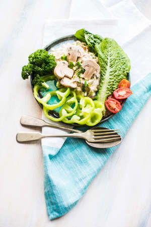 Healthy food concept with mushrooms in sour sauce and fresh vegetables on wooden tableの写真素材